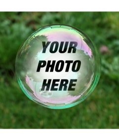 Photomontage with a soap bubble on a background of green grass where your photo will appear reflected inside the bubble